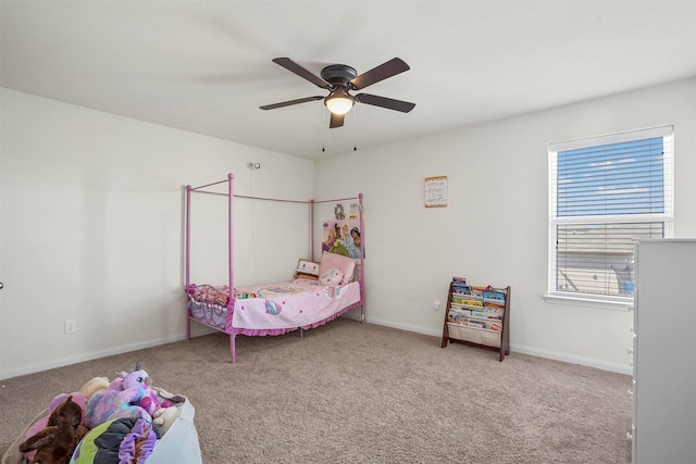 carpeted bedroom featuring ceiling fan and baseboards