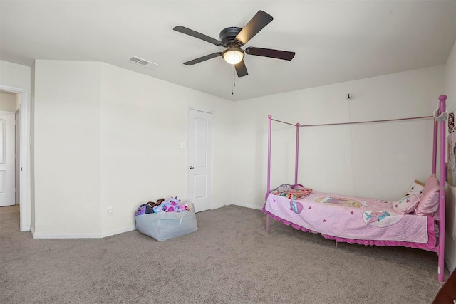 unfurnished bedroom with visible vents, carpet flooring, a ceiling fan, and baseboards