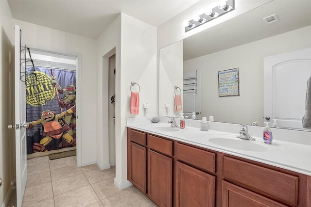 full bathroom featuring tile patterned flooring, double vanity, visible vents, and a sink