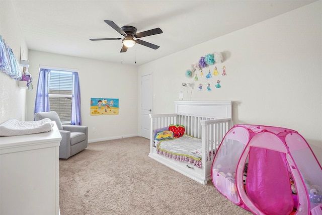 carpeted bedroom featuring baseboards and ceiling fan