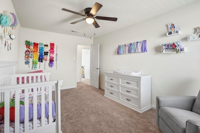 bedroom with a ceiling fan, baseboards, visible vents, and light carpet