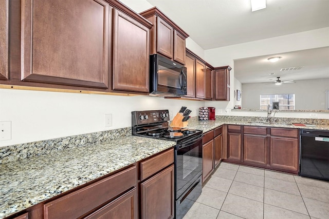 kitchen featuring black appliances, light stone counters, a ceiling fan, and a sink