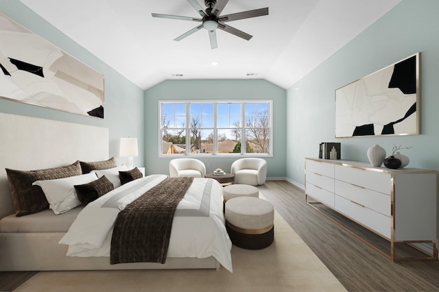 bedroom with visible vents, wood finished floors, a ceiling fan, and vaulted ceiling