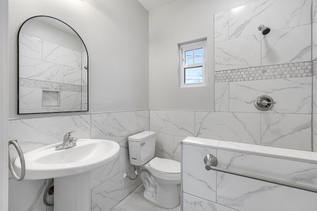 full bath featuring tile walls, toilet, and a shower