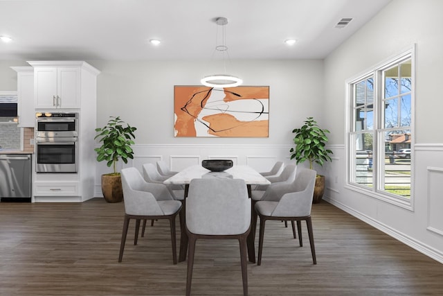 dining room featuring recessed lighting, a wainscoted wall, visible vents, and dark wood-style flooring