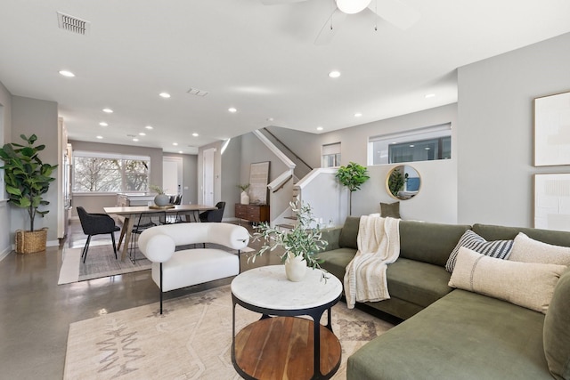 living area featuring stairway, visible vents, concrete floors, recessed lighting, and ceiling fan