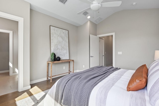 bedroom featuring lofted ceiling, wood finished floors, visible vents, and baseboards