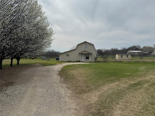 31 Rogers Cir, Krum, TX 76249 - view of front of house featuring a gambrel roof, driveway, a front yard, and fence