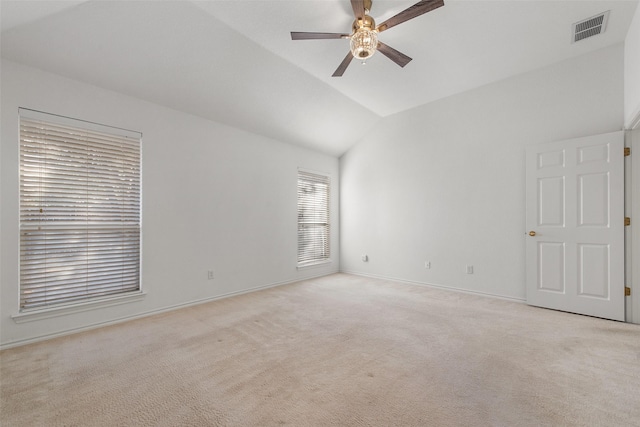 empty room featuring visible vents, baseboards, ceiling fan, light colored carpet, and lofted ceiling