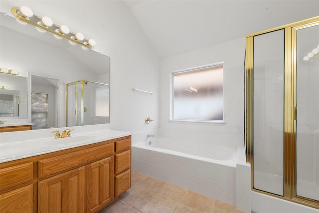 bathroom featuring vanity, vaulted ceiling, a shower stall, tile patterned floors, and a bath