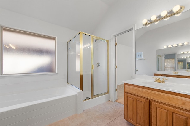 bathroom with a bath, a shower stall, vanity, and lofted ceiling