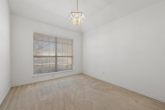 unfurnished room with a notable chandelier, baseboards, and carpet floors