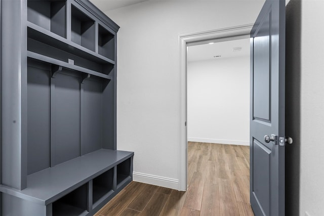 mudroom with baseboards, elevator, and wood finished floors