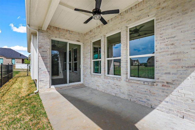 view of patio with ceiling fan and fence