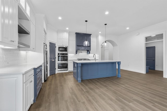 kitchen with a sink, open shelves, light countertops, and stainless steel appliances