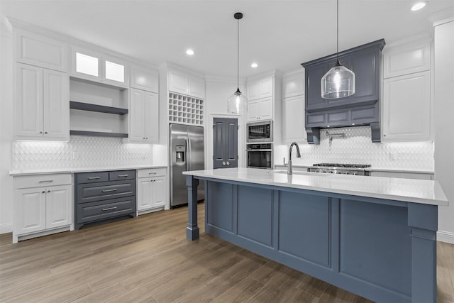 kitchen with built in appliances, white cabinetry, light countertops, and open shelves