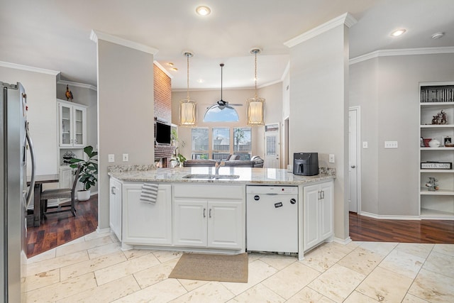 kitchen with dishwasher, white cabinets, stainless steel refrigerator with ice dispenser, and a sink