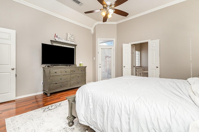 bedroom featuring visible vents, crown molding, ceiling fan, baseboards, and wood finished floors