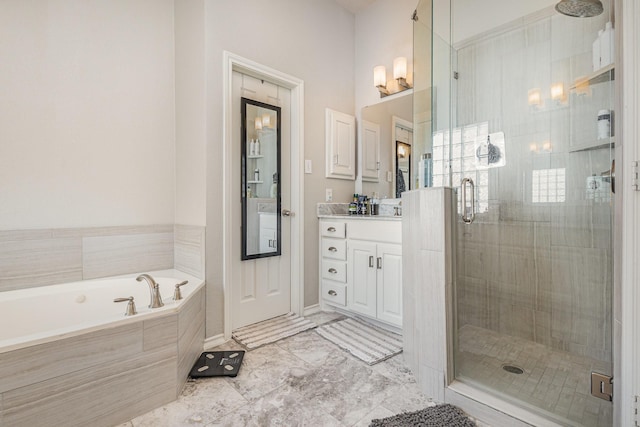 bathroom with vanity, a bath, and a stall shower