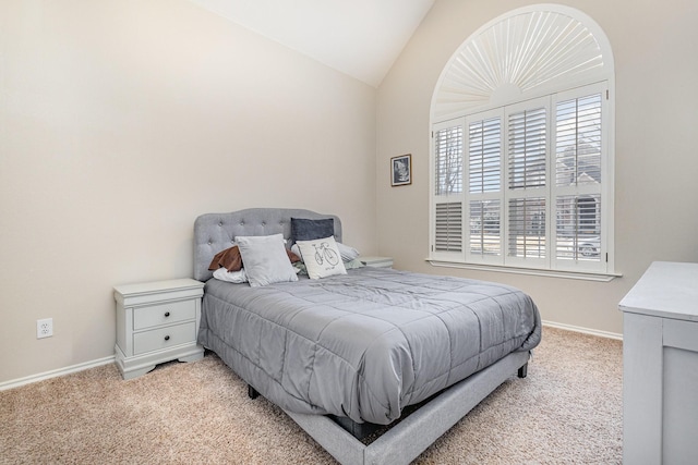 carpeted bedroom with vaulted ceiling and baseboards