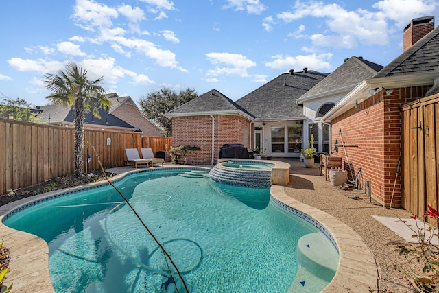 view of swimming pool featuring a pool with connected hot tub, a patio area, a fenced backyard, and grilling area