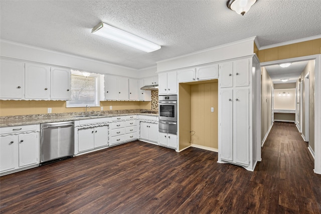 6305 Chapman Dr, Greenville, TX 75402 - kitchen featuring stainless steel appliances, a warming drawer, a sink, white cabinetry, and dark wood-type flooring