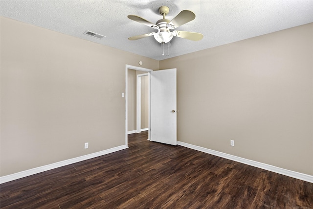 6305 Chapman Dr, Greenville, TX 75402 - empty room with dark wood-style floors, baseboards, ceiling fan, and a textured ceiling