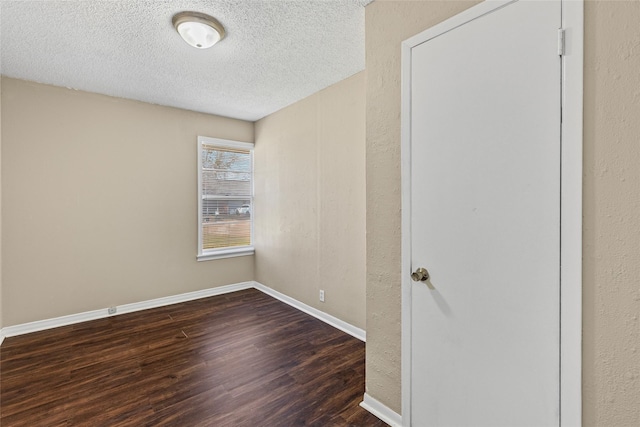 6305 Chapman Dr, Greenville, TX 75402 - empty room with wood finished floors, a textured ceiling, and baseboards