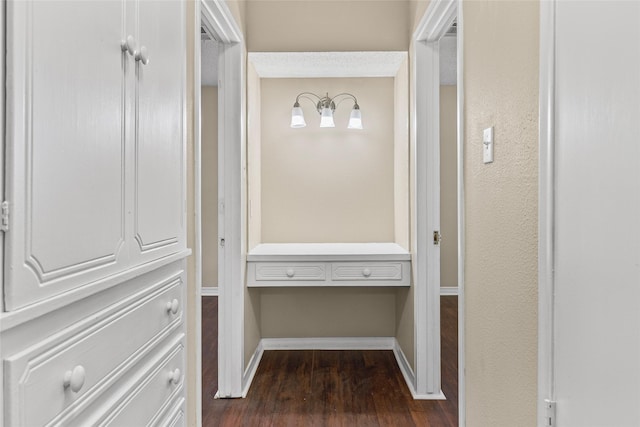 6305 Chapman Dr, Greenville, TX 75402 - corridor with dark wood-type flooring and baseboards