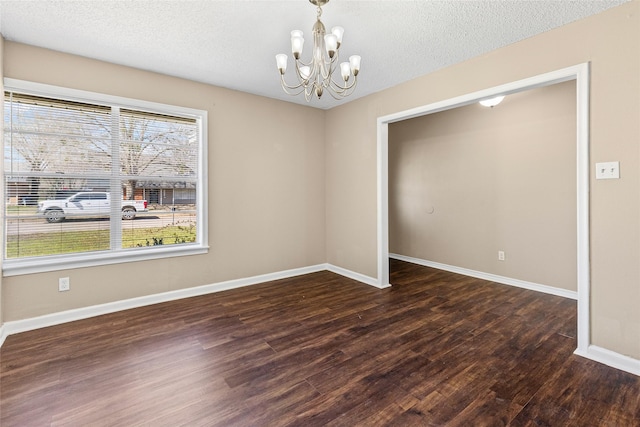 6305 Chapman Dr, Greenville, TX 75402 - spare room with wood finished floors, a chandelier, a textured ceiling, and baseboards