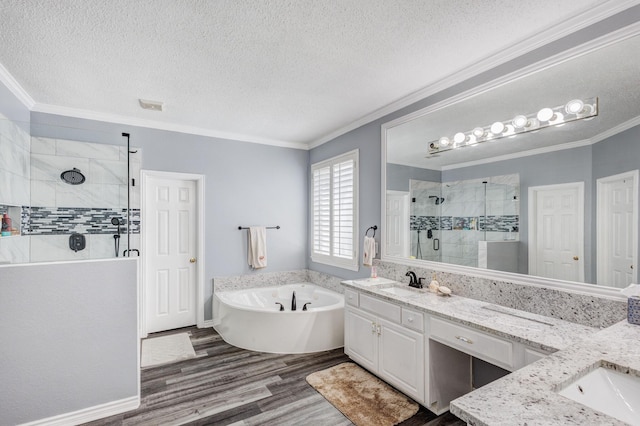 full bath with a shower stall, crown molding, a garden tub, wood finished floors, and vanity