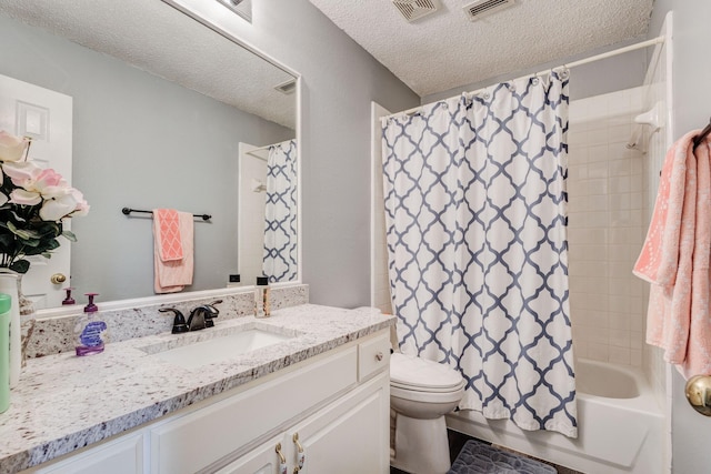 full bathroom with vanity, toilet, visible vents, and a textured ceiling