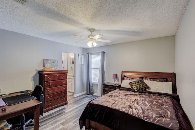 bedroom featuring ceiling fan, light wood-style floors, baseboards, and a textured ceiling