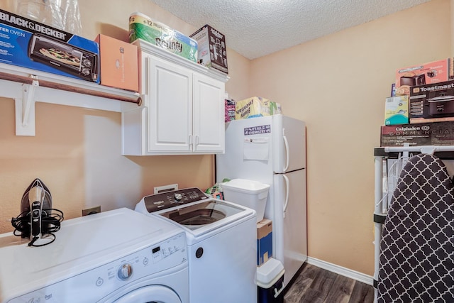 washroom featuring baseboards, washer and clothes dryer, laundry area, a textured ceiling, and dark wood-style flooring