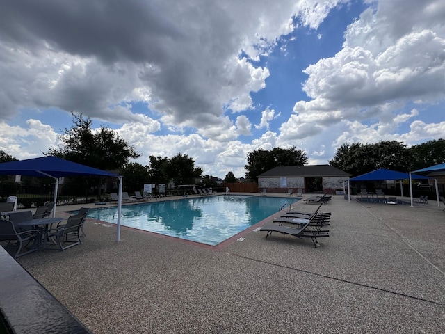 pool featuring a patio and fence