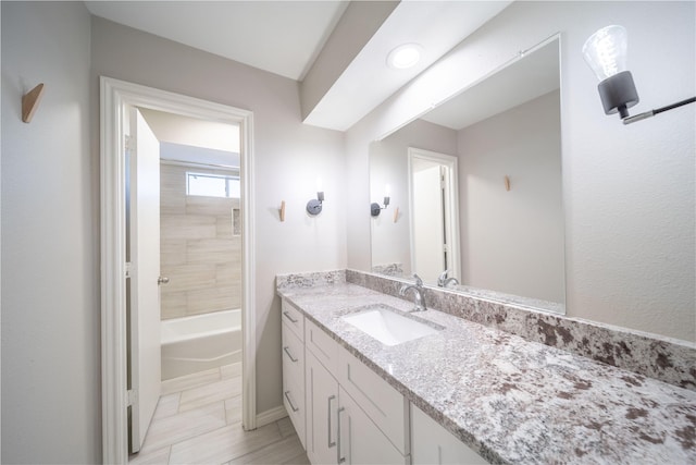 full bathroom featuring a bathing tub and vanity