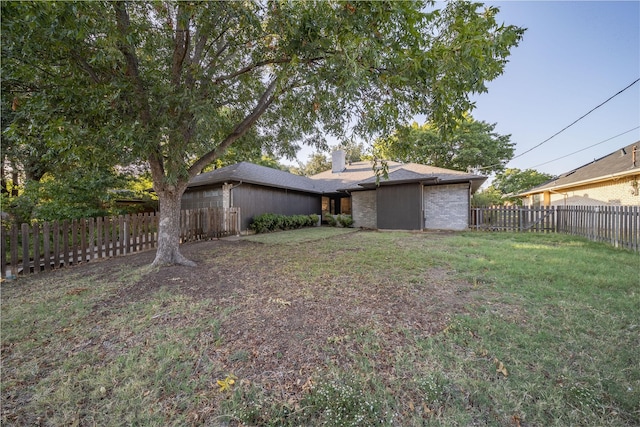 view of yard with a fenced backyard and a garage