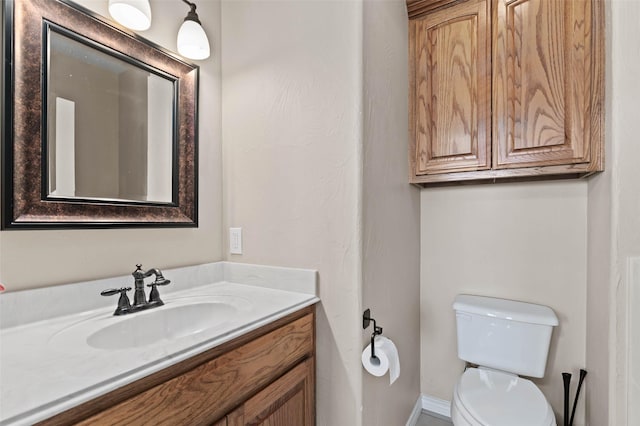 bathroom with toilet and vanity