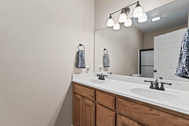 bathroom featuring double vanity and a sink