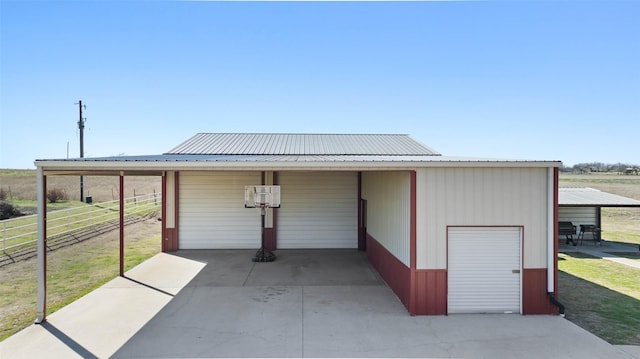 garage with a detached garage and fence