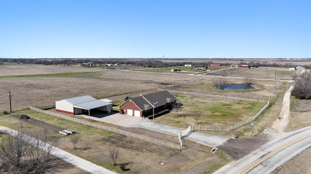 birds eye view of property with a rural view