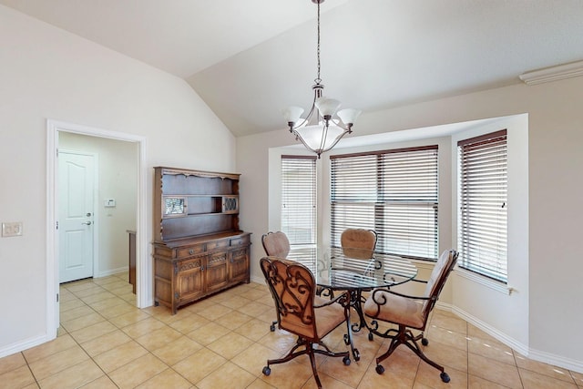 dining space with light tile patterned floors, baseboards, a chandelier, and vaulted ceiling