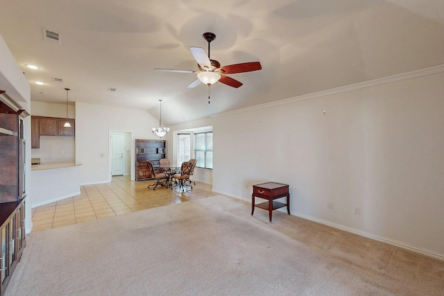 living room featuring visible vents, lofted ceiling, light tile patterned flooring, ceiling fan with notable chandelier, and light colored carpet