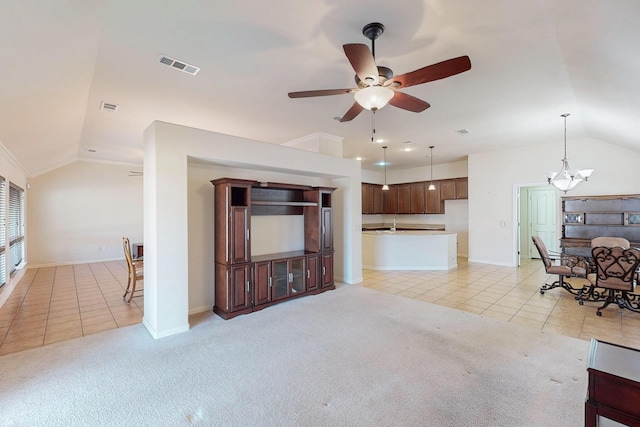 living area with vaulted ceiling, visible vents, and light carpet