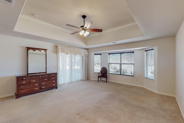 interior space featuring a tray ceiling, visible vents, and carpet flooring