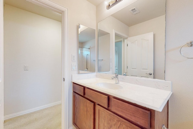 bathroom with visible vents, vanity, and baseboards