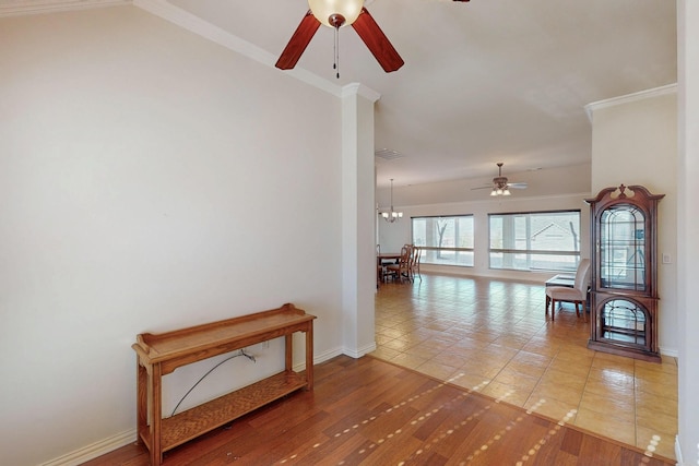 hallway with crown molding, baseboards, and wood finished floors