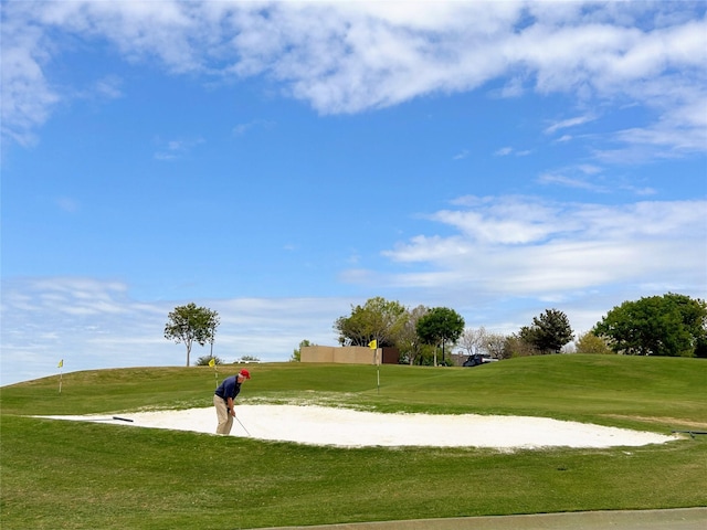 view of home's community featuring a lawn and golf course view