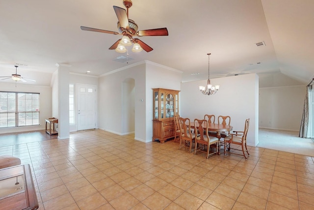 dining room with light tile patterned floors, visible vents, baseboards, ornamental molding, and ceiling fan with notable chandelier