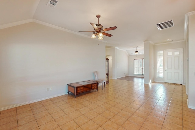 empty room featuring lofted ceiling, a ceiling fan, and visible vents